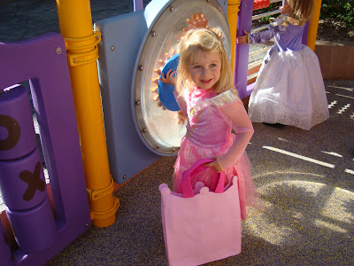 Young girl in costume with pink candy bag