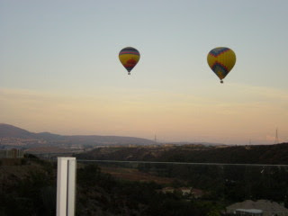 Two air balloons floating during dusk