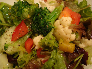 Mixed greens with vegetables topped with homemade slaw dressing
