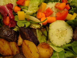 Overhead of mixed salad and potatoes on plate