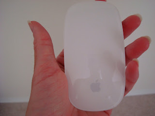 Hand holding Apple Mouse