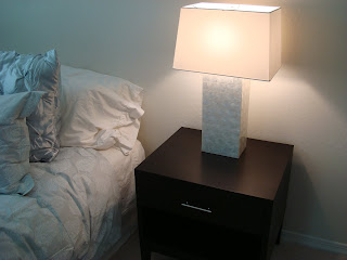 Night stand with white lamp turned on