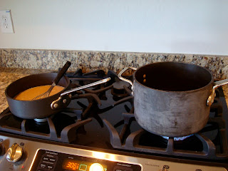Gravy being made on stove in pan with whisk