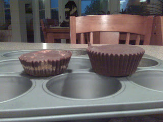 Two Peanut Butter Cups sitting on muffin tin