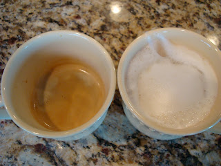 One empty mug and one mug with steamed milk latte