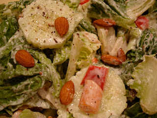 Homemade Cesar Salad up close topped with almonds