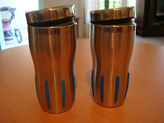 Two silver reusable mugs on tabletop