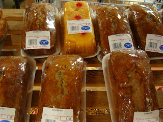Various cakes and breads packaged for purchase