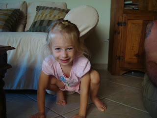 Smiling young girl crouching on ground