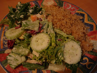 Brown Rice with Garden Salad topped with Slaw Dressing on patterned plate