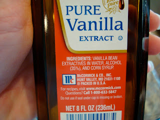 Hand holding bottle of Pure Vanilla Extract