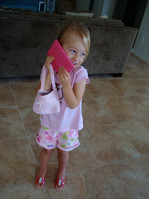 Young girl using handbag as a cell phone