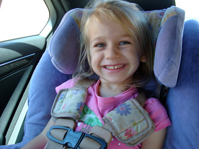 Young girl in car seat smiling