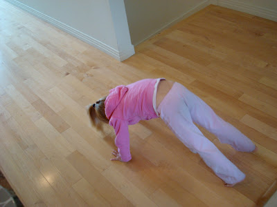 Young girl practicing yoga pose