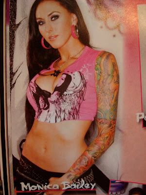 Photo of woman in magazine with a full sleeve tattoo