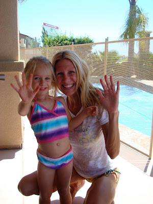 Woman and child in bathing suit waving