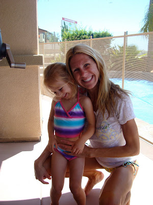 Woman and child in front of pool smiling