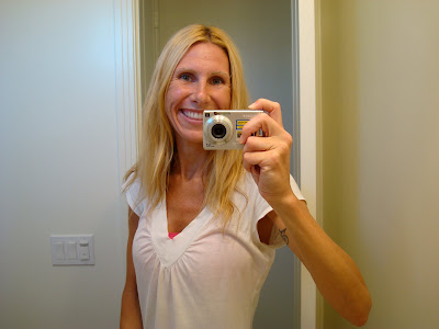 Woman taking picture in mirror smiling