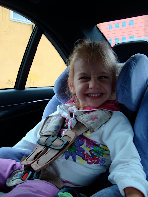 Young girl in carseat smiling