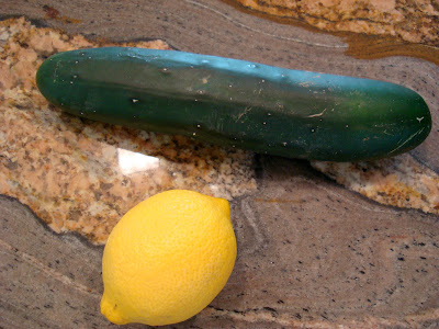 One lemon and cucumber on countertop