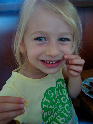 Young girl pinching cheek and smiling