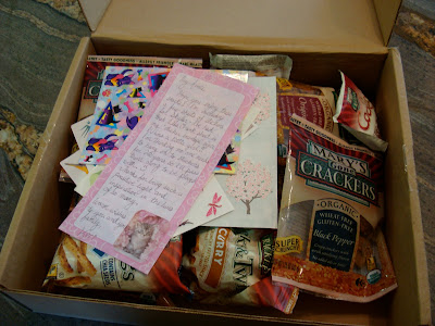 Box full of Mary's Gone Crackers with note on top