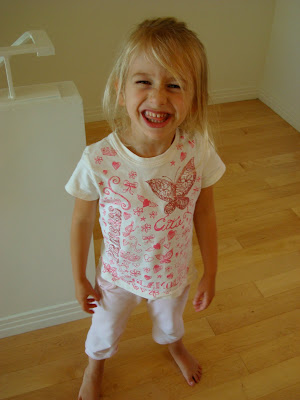 Young girl standing giving a silly smile