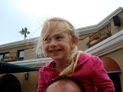 Young girl sitting on mans shoulders