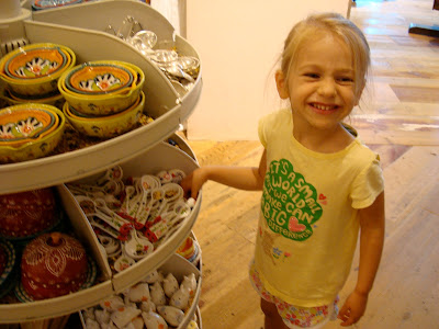 Young girl playing with spoons on display