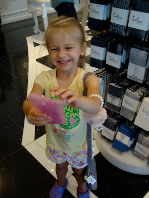 Young girl holding purse wearing jewelry and holding a manicure kit