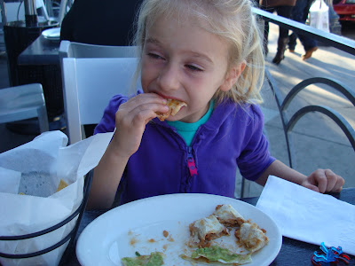 Young girl eating quesadilla