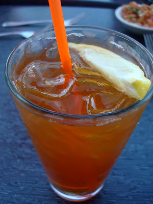Overhead of mixed drink with orange straw