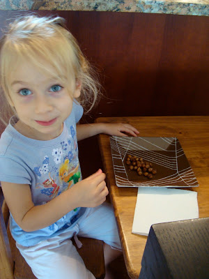 Young girl looking at camera eating Carmelized Cinnamon Sugar Roasted Chickpea Peanuts