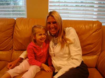 Woman and child on leather couch smiling