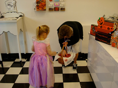 Young girl trick-or-treating in See's Candies