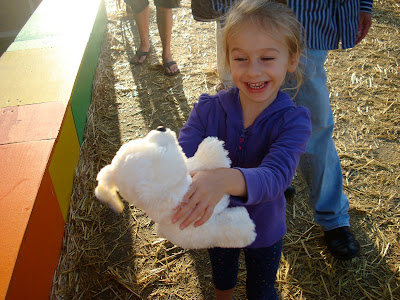 Young girl holding stuffed animal she won