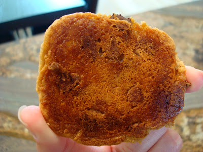 Bottomside of one Vegan GF Peanut Butter Caramel Chocolate Chip Cookie with Peanut Flour