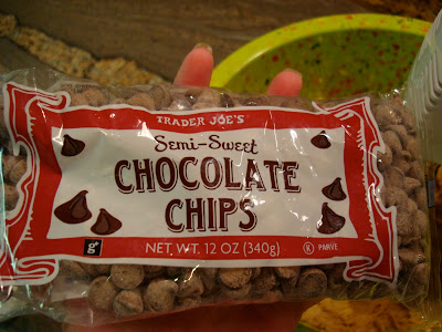 Hand holding bag of semi-sweet chocolate chips