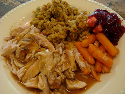 Plated turkey, stuffing, gravy and cranberry sauce