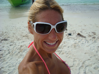 Woman on beach in white sunglasses