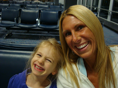 Woman sitting next to child at airport
