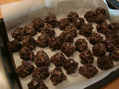 Formed Chocolate Covered Oreo Balls on parchment lined baking sheet