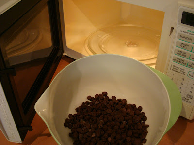 Chocolate chips tin bowl going into microwave