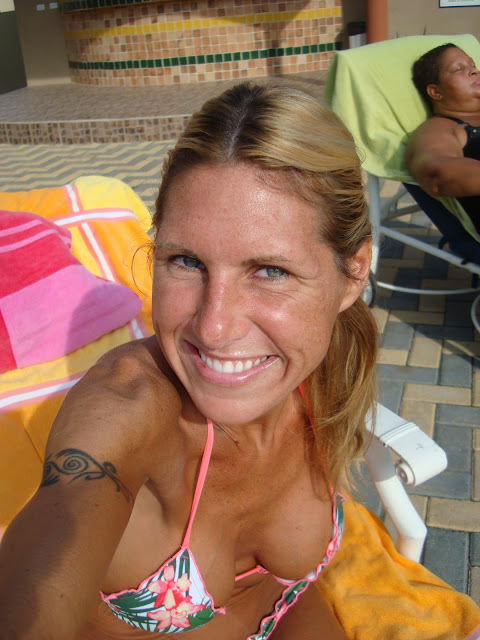 Woman in bikini smiling sitting on lounge chair