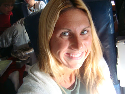 Woman sitting in airplane seat smiling