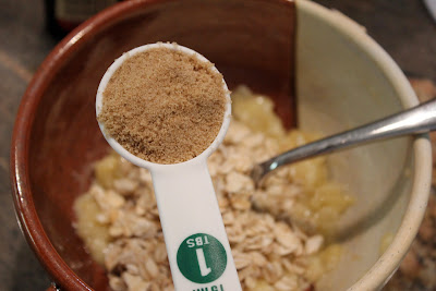Brown sugar being added to banana oat mixture