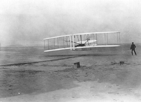 Wilbur and Orville Wright with airplane