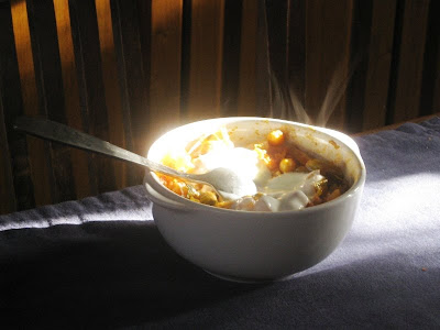 Bowl of chickpeas with dollop of yogurt and steam rising