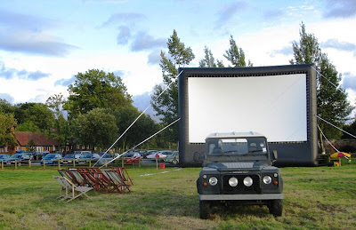 Screen and Landrover, with pub in background