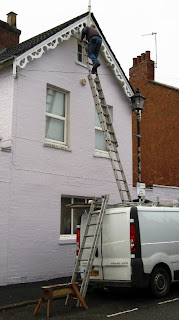 Ladders from the roof of the van to the top of the gable